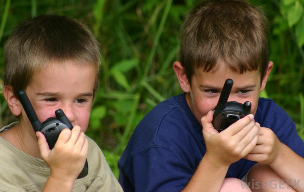 two boys playing with walkie talkies